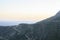 Dusk mountain landscape with views of the Mediterranean sea and cloudless sky. Golden hour, haze or fog.