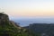 Dusk mountain landscape with views of the Mediterranean sea and cloudless sky. Golden hour, haze or fog.