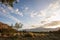 Dusk sky clouds over California meadow with hills and mountain in distance