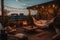 At dusk in the summer, a comfortable rooftop patio area with a lounging area, a hanging chair, and string lights is there