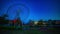 A dusk timelapse of ferris wheel at the amusement park in Odaiba Tokyo wide shot tilt