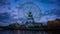 A dusk timelapse of rotating ferris wheel in Yokohama wide shot tilt