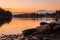 Dusk view of italian town Sesto Calende with rocks, the river, town and mountains in beautiful light