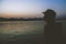 Dusk Woman Lake Silhouette against Orange Sky mountains background. Free woman enjoying freedom feeling happy at sunset. Serene