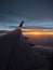 Dusky sunset behind plane wing