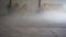 Dust flies over a dusty concrete floor