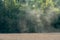 dust over an agricultural field during the operation of harvesting equipment. A field with grain crops along the forest. Farmland