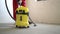 Dust removal with vacuum cleaner. A worker vacuums the floor with an industrial vacuum cleaner. Preparing the floor for