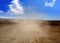 Dust road with car in brown fog at Lanzarote