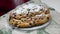 Dusting Stollen with the icing sugar. Making homemade Christmas cake