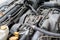 Dusty details of a flat-four boxer car engine compartment under the open hood