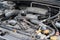 Dusty details of a flat-four boxer car engine compartment under the open hood