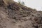 Dusty lava flow trail to the top of Batur volcano on Bali island. Slag of hardened lava on the way to the active volcano crater.