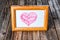 Dusty photo frame with drawing heart