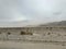 Dusty Storm in Desert with Mountains in Background