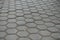 Dusty surface of gray concrete pavement with honeycomb pattern