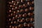 Dusty wine bottles on shelfs in cellars of winery