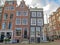 Dutch architecture on the street, famous vintage traditional Flemish buildings of Amsterdam city