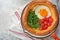 Dutch baby pancake. Fresh homemade Dutch Baby pancake with fried egg, tomato and green arugula in reed cast-iron pan on light gray