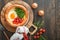 Dutch baby pancake. Fresh homemade Dutch Baby pancake with fried egg, tomato and green arugula in reed cast-iron pan on old wooden