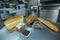 Dutch bakery products placed on a tray: bread, rolls, muffins, machines of an automatic dough line on the background