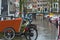 Dutch bicycle or bakfiets at Amsterdam street canal with bridge background