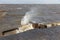 Dutch breakwater with breaking wave in heavy storm