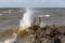 Dutch breakwater with breaking wave in heavy storm