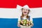 Dutch child with tulip flowers and Netherlands flag