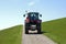 Dutch farmer driving tractor on seawall of North Sea