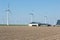 Dutch farmland with farmhouses and wind turbines