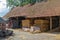 Dutch farmyard with stack of hay bales covered in shed