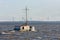 Dutch fishing ship at lake ijsselmeer with wind turbines