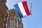 A dutch flag with streamer on the facade of a house