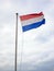 Dutch flag under typical Dutch skies