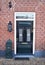 Dutch front door with mailbox and lantern. Brick house