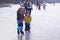 Dutch girl little brother ice skate lessons frozen lake, Netherlands