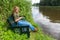 Dutch girl reading mobile phone on bench in nature
