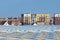 Dutch greenhouses in front of modern new built houses and apartment buildings in South Holland