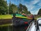 Dutch hotel barge Ros Crana exits a lock on the Caledonian Canal in the Scottish Highlands, Scotland