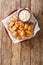 Dutch Kibbeling Deep Fried Battered Fish Pieces with remoulade sauce closeup in the plate. Vertical top view