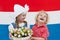 Dutch kids with tulip flowers and Netherlands flag