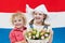 Dutch kids with tulip flowers and Netherlands flag