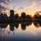Dutch landscape with windmill at dramatic sunset, Zaandam, Amsterdam, Netherlands made with Generative AI