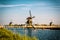 Dutch landscape with windmills, blue sky and water, Kinderdijk, Netherlands