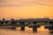 Dutch passenger train, crossing bridge at sunset