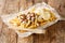 Dutch patatje oorlog means war chips and is a tasty combination of French fries, mayo, raw onions and Indonesian sauce Ñloseup in