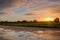 Dutch polder landscape with reflection of a multi coloured sunrise sky