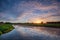 Dutch polder landscape with reflection of a multi coloured sunrise sky