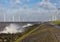 Dutch sea with off shore wind turbines and breaking waves